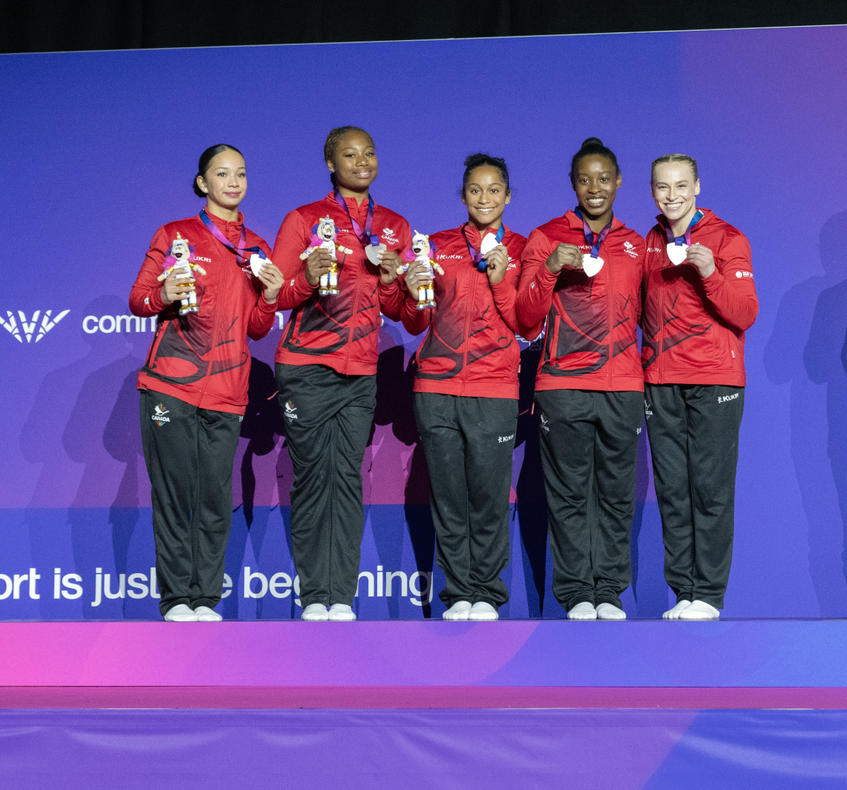 Team Canada Women's Gymnastics Team on the podium with a silver medal