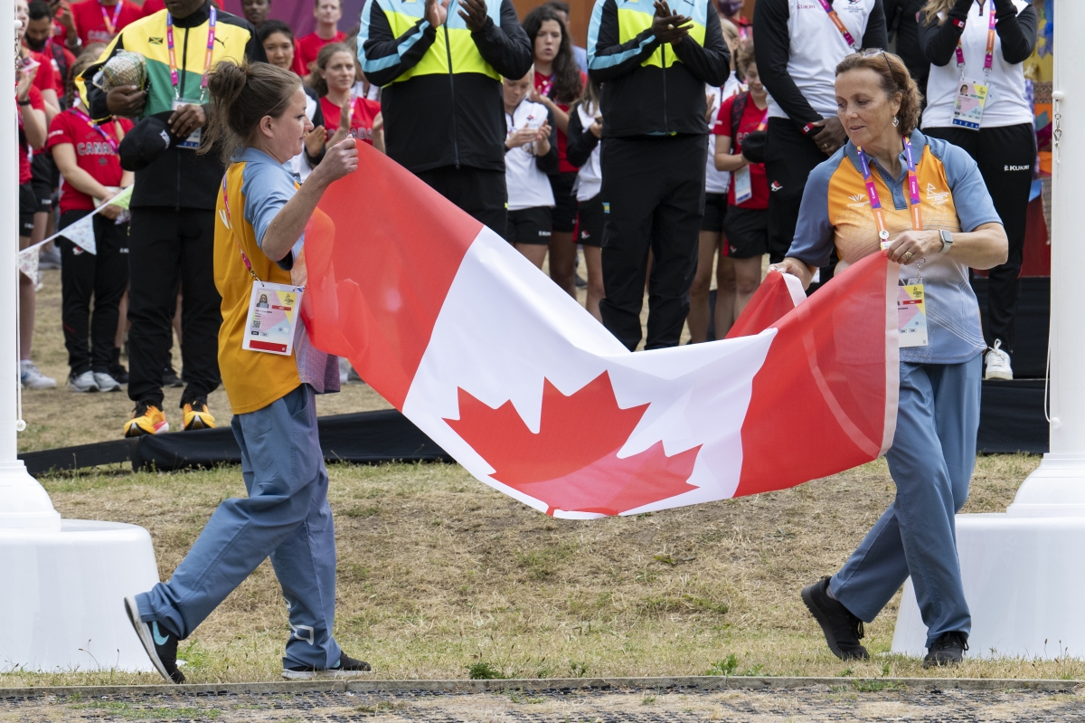 Two people holding a Canada Flag