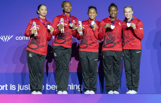 Team Canada Women's Gymnastics Team on the podium with a silver medal