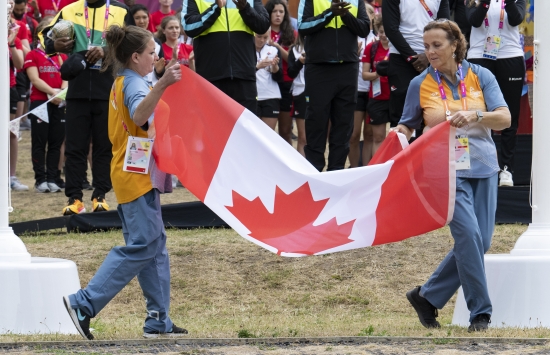Two people holding a Canada Flag