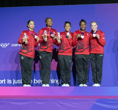 Team Canada Women's Gymnastics Team on the podium with a silver medal