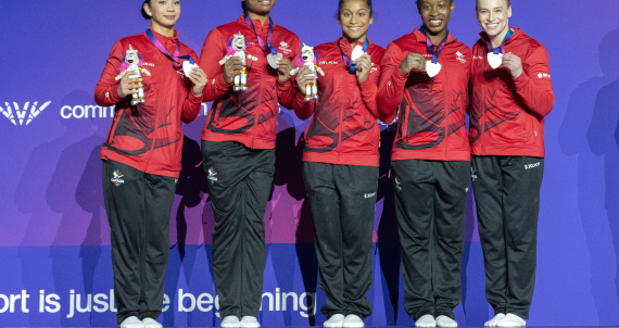 Team Canada Women's Gymnastics Team on the podium with a silver medal
