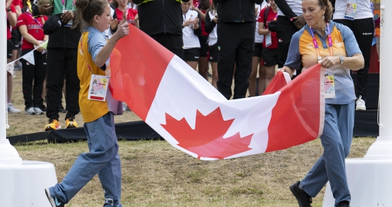 Two people holding a Canada Flag